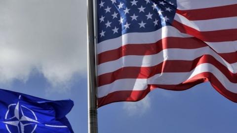 A picture taken on March 2, 2014 shows the US and NATO flags in the wind at the NATO headquarters in Brussels.  (GEORGES GOBET/AFP/Getty Images)