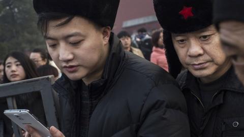A Chinese man uses his smartphone on November 20, 2014 in Beijing, China. (Kevin Frayer/Getty Images)