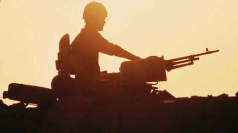 Silhouette of Challenger tank crewman in turret, circa 1991. (Roger Ryan/Crown Copyright/IWM via Getty Images)