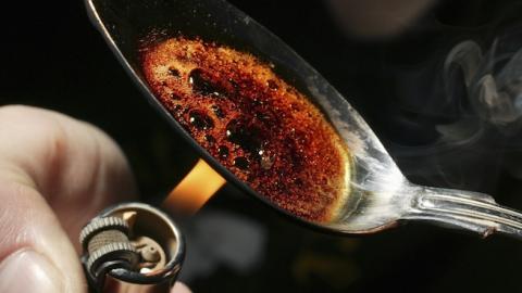 Burning heroin on a spoon. (Universal Images Group via Getty Images)