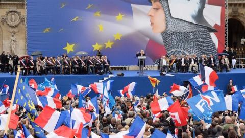 France's far-right National Front (FN) supporters watch leader Marine Le Pen (rear C) deliver a speech during a May Day rally in Paris on May 1, 2014. (PIERRE ANDRIEU/AFP/Getty Images)