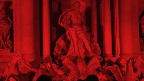 The Trevi fountain is illuminated in red to symbolize blood of persecuted Christians around the world, on April 29, 2016 in Rome. (GABRIEL BOUYS/AFP/Getty Images)