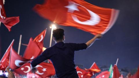 People carry Turkish flags at Taksim Square in Istanbul, Turkey on July 17, 2016 as they gather to protest the failed military coup attempt. ( Onur Coban/Anadolu Agency/Getty Images)