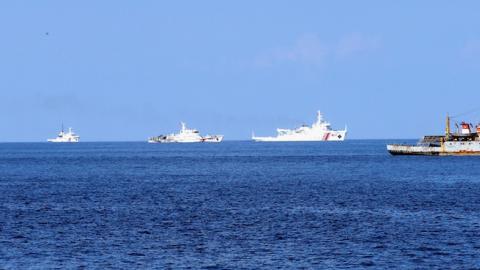 A Vietnamese fisheries surveillance force vessel (R) is chased by Chinese Maritime Police Bureau ships on May 27, 2014 (Photo by The Asahi Shimbun via Getty Images)
