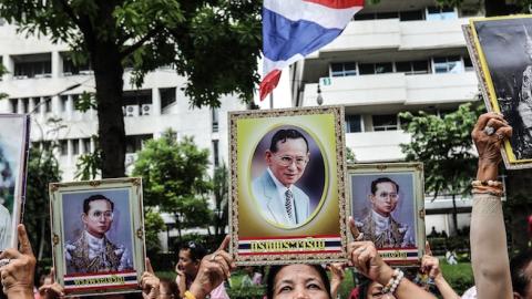 People hold portraits of Thai King Bhumibol Adulyadej at Siriraj hospital, on June 13, 2016 in Bangkok, Thailand. (Dario Pignatelli/Getty Images)
