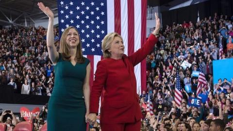 Democratic presidential nominee Hillary Clinton and Chelsea Clinton wave after a midnight rally at Reynolds Coliseum November 8, 2016 in Morrisville, North Carolina. (BRENDAN SMIALOWSKI/AFP/Getty Images)