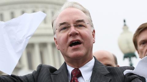 U.S. Rep. Tom Price (R-GA) tears a page from the national health care bill during a press conference at the U.S. Capitol March 21, 2012 in Washington, DC. (Win McNamee/Getty Images)