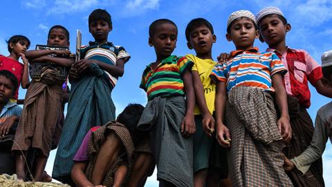 Rohingya refugee children look on at the Kutupalong camp in Ukhia, August 12, 2018 (CHANDAN KHANNA/AFP/Getty Images)