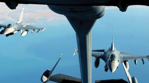 Two F-16 Fighting Falcons fly in formation behind a KC-10 Extender from Al Dhafra Air Base, United Arab Emirates, Dec. 25, 2021. (U.S. Air Force)
