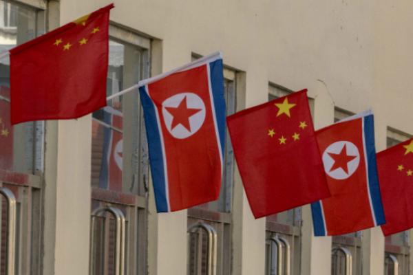 Chinese and North Korean flags outside the Sino-Korea bilateral trade market (Zhang Peng/LightRocket via Getty Images)