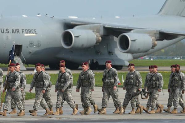 Members of the U.S. Army 173rd Airborne Brigade disembark upon their arrival by plane at a Polish air force base on April 23, 2014, in Swidwin, Poland. (Getty Images)