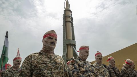 Members of the IRGC parade under an Iranian Kheibar Shekan Ballistic missile in downtown Tehran on April 29, 2022. (Morteza Nikoubazl/NurPhoto via Getty Images)