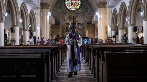 A priest recites the stations of the cross prayers at the Holy Cross Cathedral in Lagos, Nigeria, on February 24, 2023. (John Wessels/AFP via Getty Images)