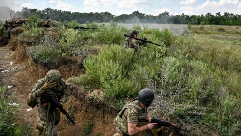 Servicemen of the 128th Separate Brigade of Territorial Defense Forces practice storming enemy positions during a tactical drill in the Zaporizhzhia direction, southeastern Ukraine. (Ukrinform/NurPhoto via Getty Images)