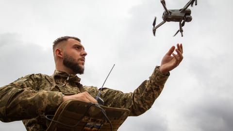 A serviceman launches a drone during a press tour to demonstrate the integration of AI into the process of humanitarian demining in the Zhytomyr Region, northern Ukraine, on September 20, 2023. (Kirill Chubotin/Ukrinform/Future Publishing via Getty Images)