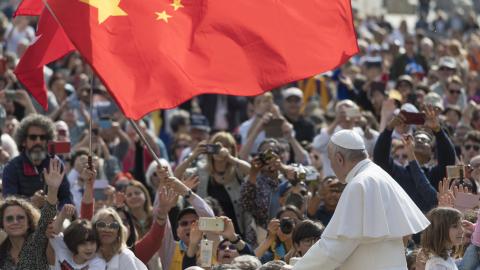 A group of pilgrim from China waves a red flag during the Pope Francis weekly general audience in St Peter Square at the Vatican, Wednesday, May 22, 2019. (Photo by Massimo Valicchia/NurPhoto via Getty Images)