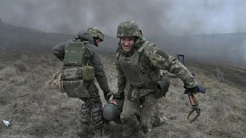 Ukrainian servicemen of the Skala battalion perform a medical evacuation during a field military exercise in the Donetsk region on February 3, 2024, amid the Russian invasion of Ukraine. (Photo by Genya SAVILOV / AFP) (Photo by GENYA SAVILOV/AFP via Getty Images)