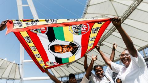 Inkatha Freedom Party (IFP) supporters hold a flag depicting former IFP leader Mangosuthu Buthelezi in Durban, South Africa, on March 10, 2024. (Photo by Rajesh Jantilal/AFP via Getty Images)