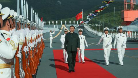 Xi Jinping boards the aircraft carrier Shandong and reviews the guard of honor at a naval port in Sanya, south China's Hainan Province, Dec. 17, 2019. Xi attended the commissioning ceremony of China's first domestically built aircraft carrier, the Shandong, on the same day. The new aircraft carrier, named after Shandong Province in east China, was delivered to the Navy of the Chinese People's Liberation Army and placed in active service at the naval port. TO GO WITH "Profile: Xi Jinping, the man who leads C