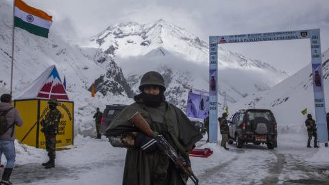 Indian soldiers stand guard at the Srinagar-Leh Highway on March 19, 2022, in Kashmir, India. (Yawar Nazir/Getty Images)