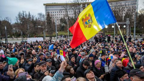 Moldovans hold national flags at a rally in the courtyard of Moldovan presidential headquarters in Chisinau, Moldova, on December 17, 2023. (Photo by Elena Covalnco/AFP via Getty Images)