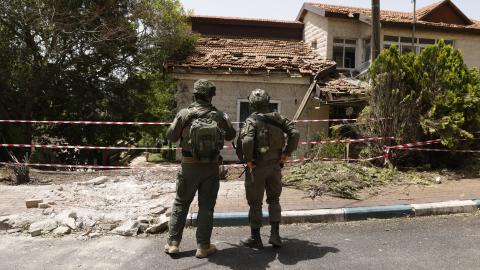 A picture taken during a tour with the Israeli army in Dovev, a Moshav in north Israel close to the border with Lebanon, shows Israeli soldiers inspecting the damage to a synagogue after it was hit by rockets fired from Lebanon on May 27, 2024. (Photo by Jalaa MAREY / AFP) (Photo by JALAA MAREY/AFP via Getty Images)