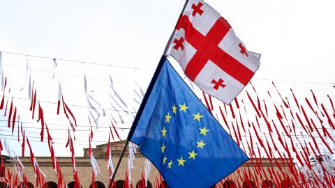 A protester waves Georgian and European Union flags in Tbilisi, Georgia, on May 28, 2024. (Photo by Giorgi Arjevanidze/AFP via Getty Images)
