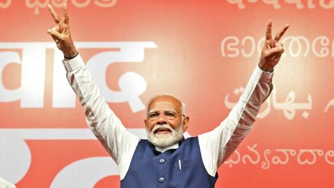 Narendra Modi flashes victory sign in New Delhi on June 4, 2024. (Money Sharma/AFP via Getty Images)