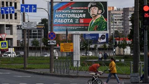 A billboard promoting contract army service with an image of a serviceman and the slogan reading "Serving Russia is a real job" sits in Saint Petersburg on September 20, 2022. (Photo by Olga MALTSEVA / AFP) (Photo by OLGA MALTSEVA/AFP via Getty Images)
