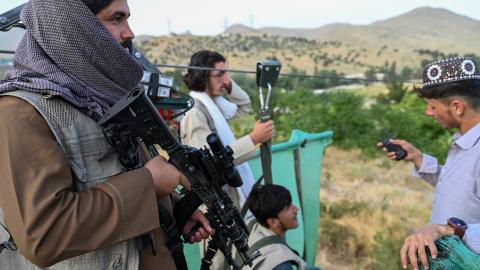 A Taliban security personnel holds his gun near the Qargha lake on the outskirts of Kabul on July 4, 2024. (Photo by Wakil Koshar / AFP via Getty Images)