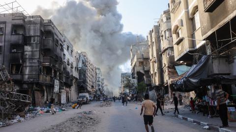 Palestinians rush toward a column of smoke after an Israeli strike in Gaza City on August 3, 2024. (Omar Al-Qattaa/AFP via Getty Images)