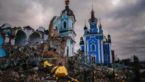 Construction workers climb onto the roof of a destroyed church on January 4, 2023, in the village of Bohorodychne, Donetsk region. (Dimitar Dilkoff/AFP via Getty Images)