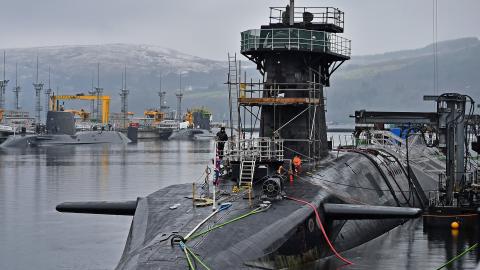 Royal Navy security personnel stand guard on HMS Vigilant at Her Majesty's Naval Base, Clyde on January 20, 2016 in Rhu, Scotland. HMS Vigilant is one of the UK's fleet of four Vanguard class nuclear-powered ballistic missile submarines carrying the Trident nuclear missile system. A decision on when to hold a key Westminster vote on renewing Trident submarine class is yet to be decided senior Whitehall sources have admitted. (Photo by Jeff J Mitchell/Getty Images)