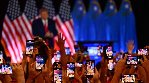 People hold up smart phones to photograph former US President and 2024 Republican Presidential hopeful Donald Trump speak at a Republican volunteer recruitment event at Fervent, a Calvary Chapel, in Las Vegas, Nevada, July 8, 2023. (Photo by Patrick T. Fallon / AFP) (Photo by PATRICK T. FALLON/AFP via Getty Images)