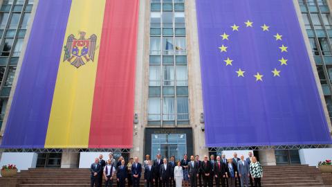 Moldovan President Maia Sandu and European Union Commissioner for Budget and Administration Johannes Hahn pose in front of the Moldovan and EU flags in Chisinau, Moldova, on May 9, 2024. (Elena Covalenco via Getty Images)