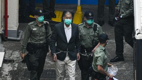 Jimmy Lai, founder and owner of Apple Daily, is seen handcuffed and escorted by guards on December 12, 2020, in Hong Kong, China. (Keith Tsuji via Getty Images)