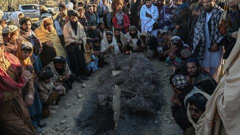 Afghan men gather around the grave of Khalil Ur-Rahman Haqqani during the funeral ceremony in Sarana, Kabul, on December 12, 2024. (Wakil Kohsar via Getty Images)