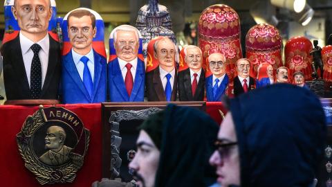 People walk past traditional Russian matryoshka dolls bearing Russian and Soviet leaders in downtown Moscow on December 16, 2018. (Vasily Maximov/AFP via Getty Images)