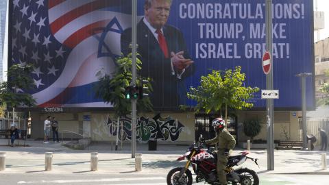 People pass by a congratulatory billboard showing elected United States President Donald Trump on November 7, 2024, in Tel Aviv, Israel. (Amir Levy via Getty Images)