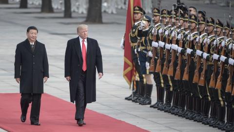 China's President Xi Jinping and US President Donald Trump review Chinese honour guards during a welcome ceremony at the Great Hall of the People in Beijing on November 9, 2017. (Fred Dufour/AFP via Getty Images)