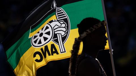 A performer holds an African National Congress flag while listening to Cyril Ramaphosa speak during the ANC Siyanqoba Rally on May 25, 2024, in Johannesburg, South Africa. (Chris McGrath via Getty Images)