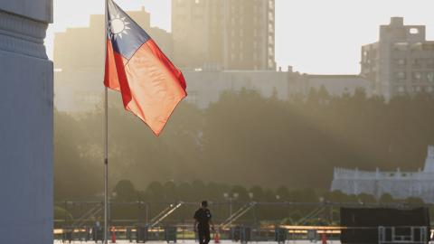 A man walks past a hoisted Taiwanese flag at the Chiang Kai-shek Memorial Hall in Taipei on October 15, 2024. (I-Hwa Cheng/AFP via Getty Images)