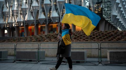 A woman carries a Ukrainian flag during a rally outside the United States embassy on March 5, 2025, in London, England. (Carl Court via Getty Images)