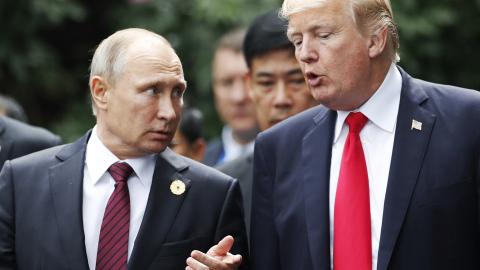 US President Donald Trump (R) and Russia's President Vladimir Putin talk as they make their way to take the "family photo" during the Asia-Pacific Economic Cooperation (APEC) leaders' summit in the central Vietnamese city of Danang on November 11, 2017. World leaders and senior business figures are gathering in the Vietnamese city of Danang this week for the annual 21-member APEC summit. (Photo by JORGE SILVA / POOL / AFP) (Photo by JORGE SILVA/POOL/AFP via Getty Images)