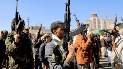 Houthi fighters brandish their weapons during a march in solidarity with the Palestinian people in the Houthi-controlled capital Sanaa on January 11, 2024. (Mohammed Huwais/AFP via Getty Images)