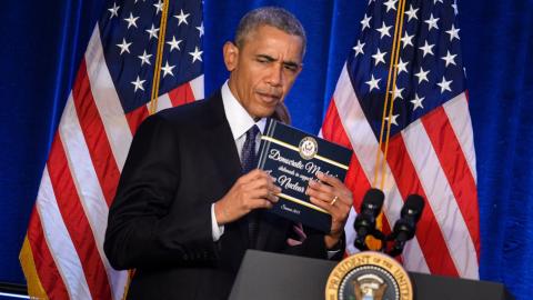 President Barack Obama holds a copy of the Iran nuclear agreement presented to him by House Minority Leader Nancy Pelosi during the House Democratic Issues Conference on January 28, 2016, in Baltimore, Maryland. (Brendan Smialowski via Getty Images)