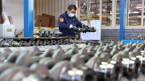 A quality inspector checks crankshafts at a factory that produces the mechanical component for the domestic market and export in Binzhou, China, on December 10, 2024. (Getty Images)