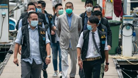 Hong Kong media tycoon and Apple Daily founder Jimmy Lai is escorted by the police to the Royal Hong Kong Yacht Club Shelter Cove Clubhouse for evidence collection as part of the ongoing investigations on August 11, 2020, in Hong Kong, China. (Anthony Kwan via Getty Images)