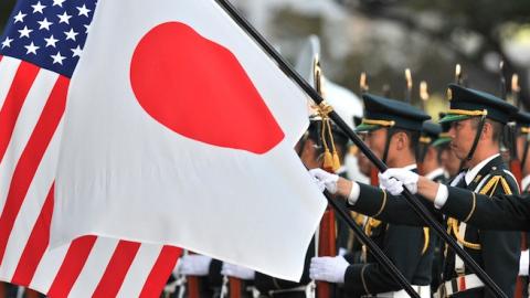 A unit of the Japanese Ground Self Defense Force honor guards hold national flags for visiting US Army General Martin E. Dempsey, chairman of the Joint Chiefs of Staff at the Defence Ministry in Tokyo on October 28, 2011. (KAZUHIRO NOGI/AFP/Getty Images)