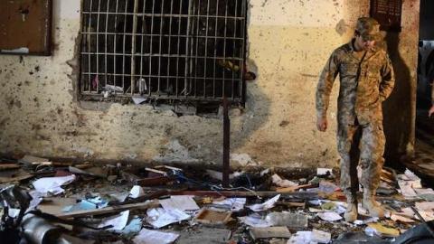 A Pakistani soldier walks amidst the debris in an army-run school a day after an attack by Taliban militants in Peshawar on December 17, 2014. (A Majeed/AFP/Getty Images)